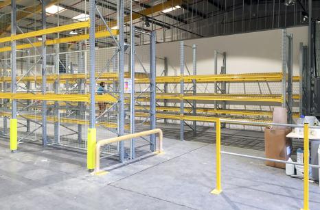 New pallet racking installation showing mesh decks end-of-rack protection, upright protection and padestrian handrails