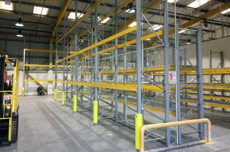 Newly installed pallet racking racking with full upright protection and anti-collapse mesh walkway space to allow fork lift access