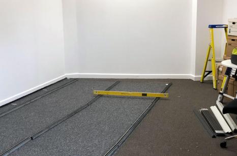 levelling track in preparation for floor mobile shelving